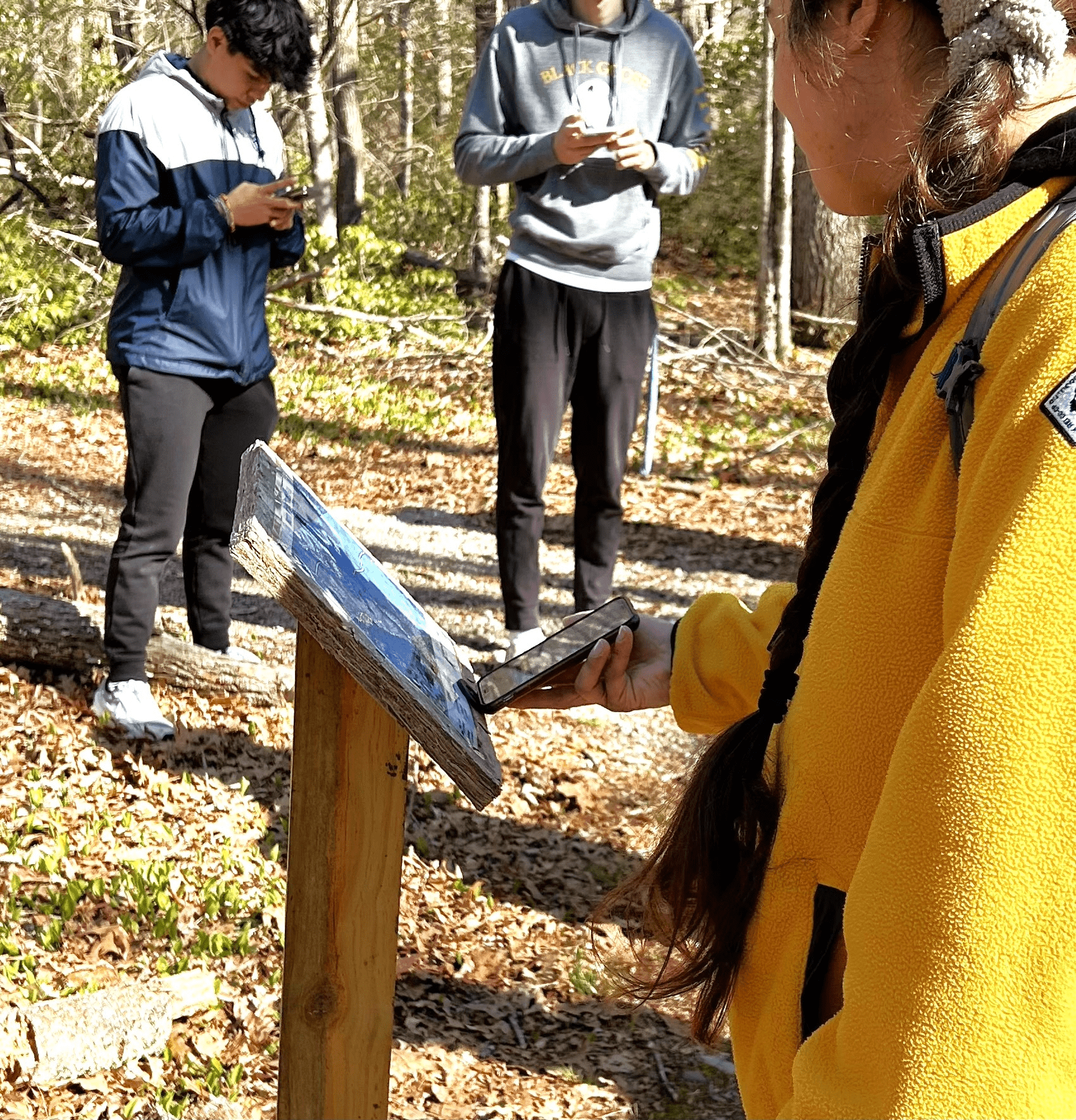 graduate students from the university of rhode island test out the nfc chips attached to a trail map using mobile devices